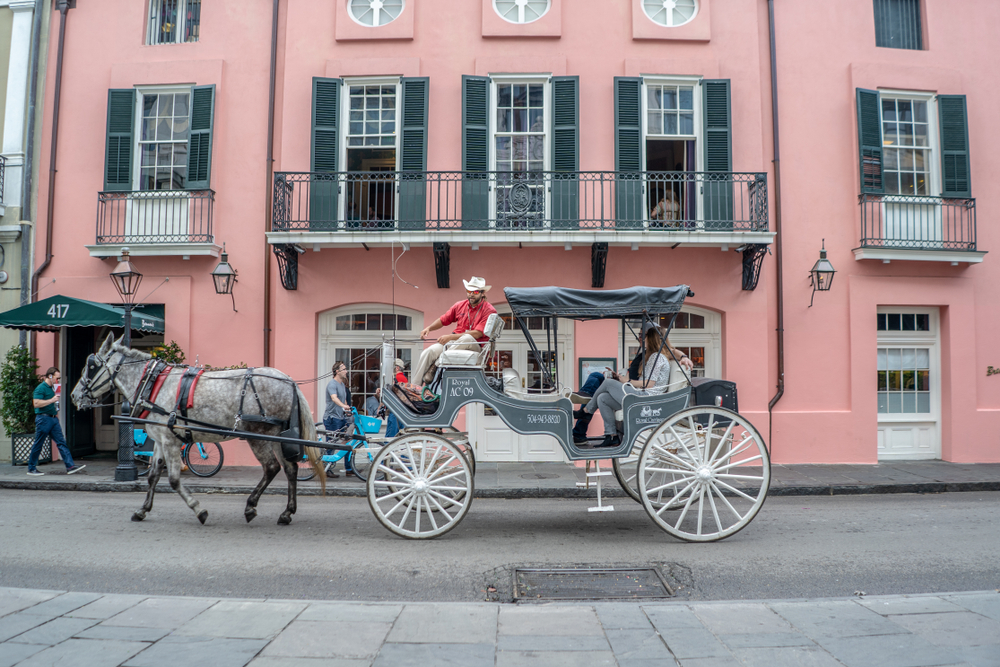 People enjoying a horse drawn carriage ride along the French Quarter