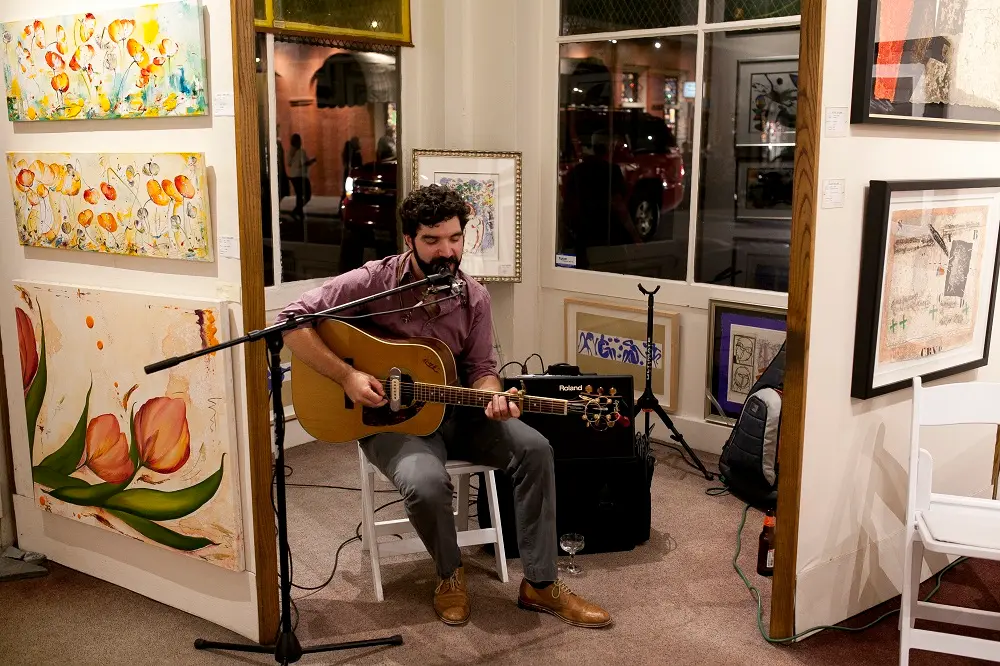 elliott-gallery-events Performing live music: a guitarist plays during an event at Elliott Gallery, an art gallery in New Orleans